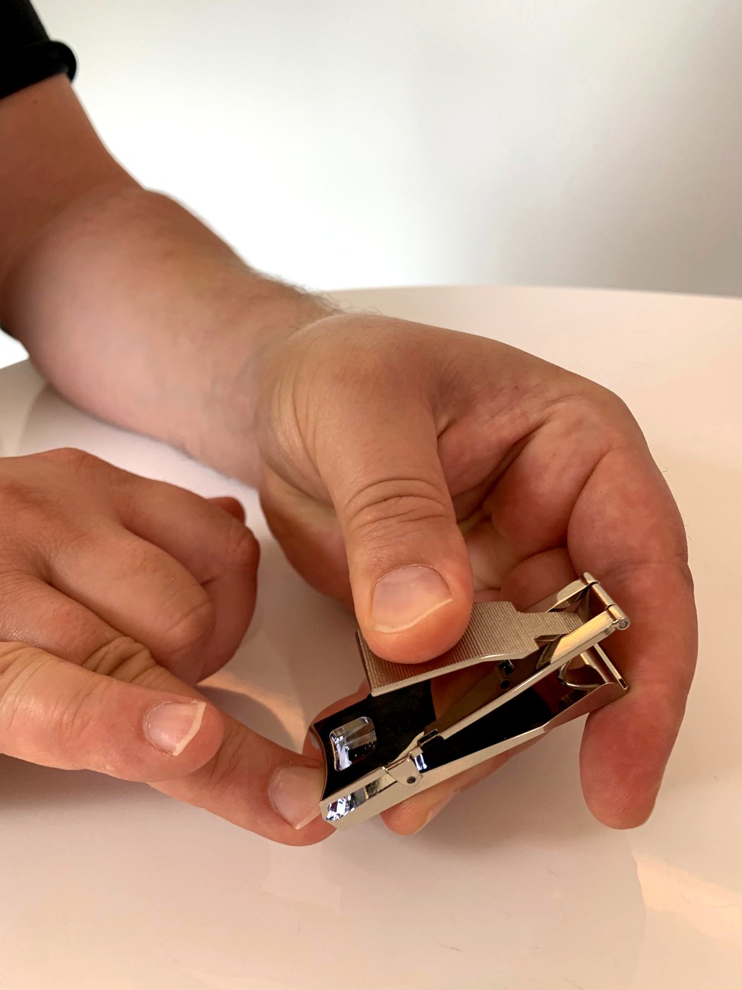 Person using the authentic EClipped nail clipper in hand